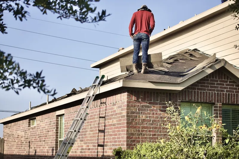 Professional roofer working on a residential roof in Falmouth Heights